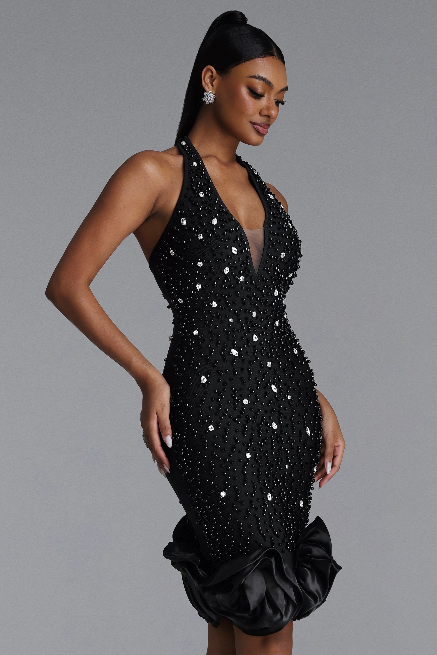 BLACK MIDI DRESS WITH CRYSTALS, DEEP DOCK AND A DECORATIVE BOTTOM