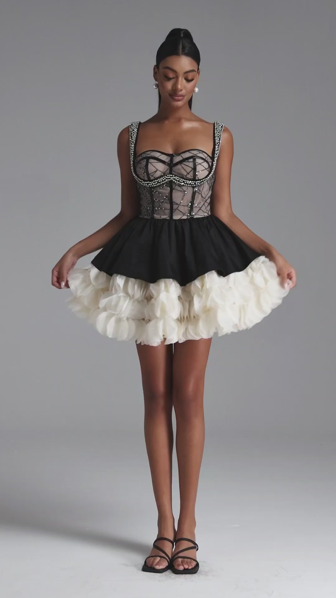 BLACK AND CREAM MINI DRESS WITH A DECORATIVE GORST AND A FLORAL BOTTOM